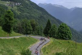 The peloton races through the mountainous French landscape during Tour Auvergne-Rhône-Alpes 2026.