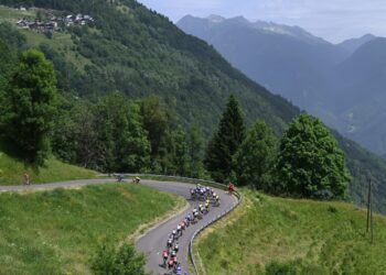The peloton races through the mountainous French landscape during Tour Auvergne-Rhône-Alpes 2026.