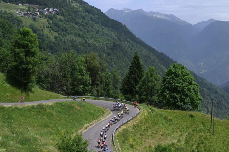 The peloton races through the mountainous French landscape during Tour Auvergne-Rhône-Alpes 2026.
