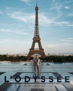 The cast of The Odyssey gathers in Paris beneath the Eiffel Tower for a twilight photo shoot.