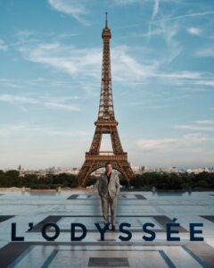 The cast of The Odyssey gathers in Paris beneath the Eiffel Tower for a twilight photo shoot.