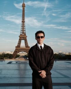 The cast of The Odyssey gathers in Paris beneath the Eiffel Tower for a twilight photo shoot.