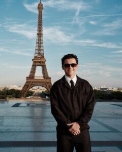The cast of The Odyssey gathers in Paris beneath the Eiffel Tower for a twilight photo shoot.