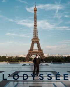 The cast of The Odyssey gathers in Paris beneath the Eiffel Tower for a twilight photo shoot.