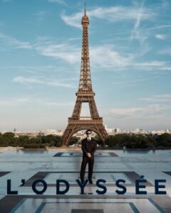 The cast of The Odyssey gathers in Paris beneath the Eiffel Tower for a twilight photo shoot.