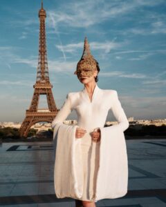 The cast of The Odyssey gathers in Paris beneath the Eiffel Tower for a twilight photo shoot.