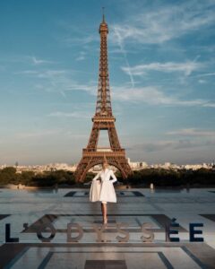 The cast of The Odyssey gathers in Paris beneath the Eiffel Tower for a twilight photo shoot.