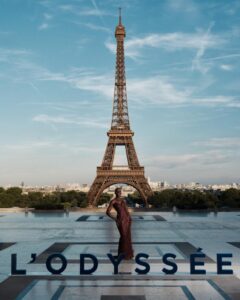 The cast of The Odyssey gathers in Paris beneath the Eiffel Tower for a twilight photo shoot.