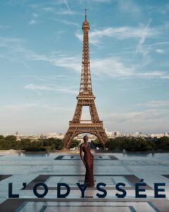 The cast of The Odyssey gathers in Paris beneath the Eiffel Tower for a twilight photo shoot.