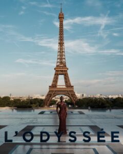 The cast of The Odyssey gathers in Paris beneath the Eiffel Tower for a twilight photo shoot.