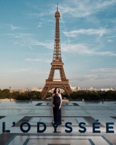 The cast of The Odyssey gathers in Paris beneath the Eiffel Tower for a twilight photo shoot.