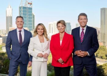 7NEWS Perth presenters standing in front of the Perth city skyline