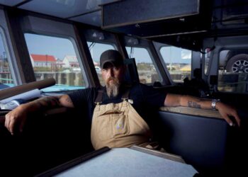 Jeff Mackinnon sits inside a boat in The Death Coast final episode on SBS Viceland.