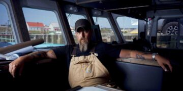 Jeff Mackinnon sits inside a boat in The Death Coast final episode on SBS Viceland.