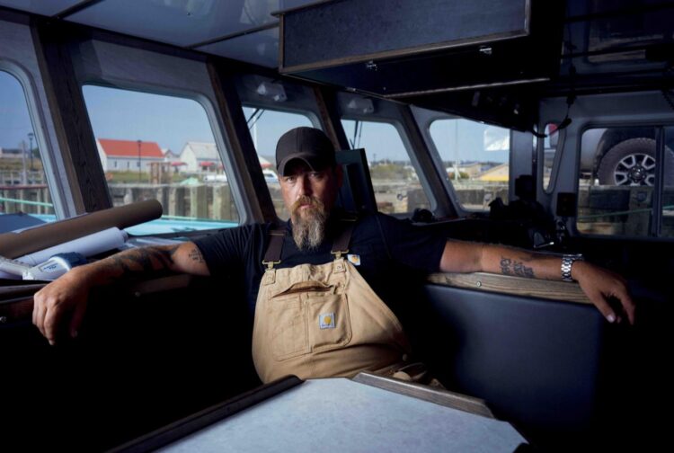 Jeff Mackinnon sits inside a boat in The Death Coast final episode on SBS Viceland.
