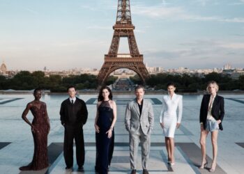 The cast of The Odyssey gathers in Paris beneath the Eiffel Tower for a twilight photo shoot.