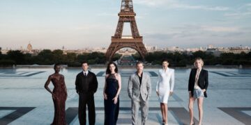 The cast of The Odyssey gathers in Paris beneath the Eiffel Tower for a twilight photo shoot.