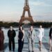 The cast of The Odyssey gathers in Paris beneath the Eiffel Tower for a twilight photo shoot.