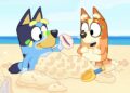 Bluey and Bingo on the beach in a still from Bluey.