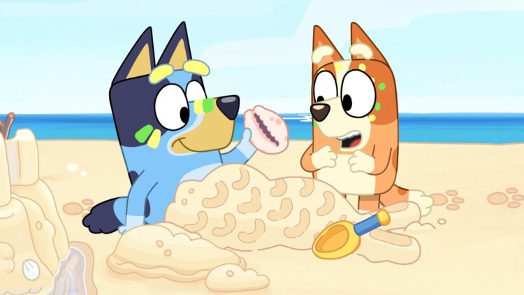 Bluey and Bingo on the beach in a still from Bluey.