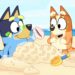 Bluey and Bingo on the beach in a still from Bluey.