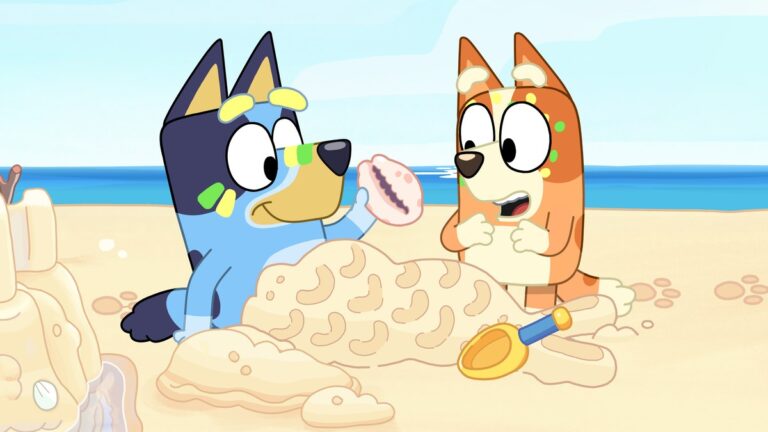 Bluey and Bingo on the beach in a still from Bluey.