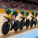 Australian women's pursuit cyclists ride in formation on an indoor velodrome