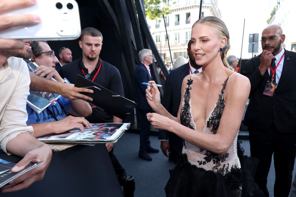 Charlize Theron meets fans at The Odyssey Paris premiere