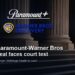 Paramount+ and Warner Bros. Discovery official logos over a courthouse background for the Paramount-Warner Bros deal court test story.