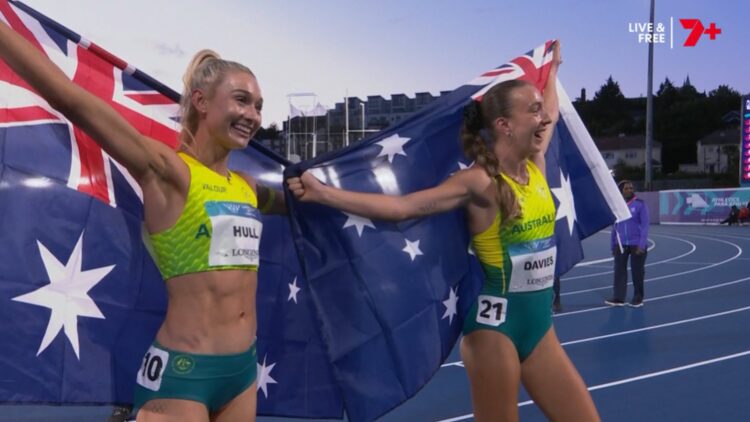 Rose Davies and Jess Hull celebrate their Glasgow 2026 5000m one-two with Australian flags