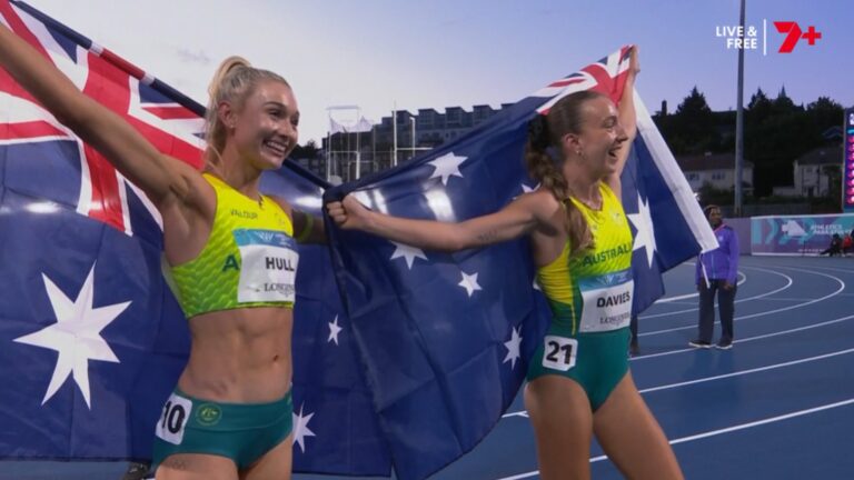 Rose Davies and Jess Hull celebrate their Glasgow 2026 5000m one-two with Australian flags