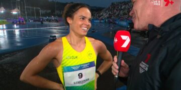 Torrie Lewis reacts after running under 11 seconds at Glasgow 2026.