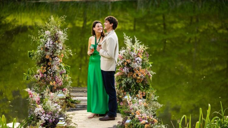 Zac and Maya from Farmer Wants A Wife 2026 standing together beside a lake