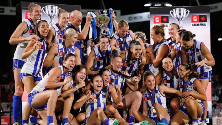 North Melbourne players celebrate with the AFLW premiership cup