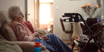 An older woman seated at home in Four Corners: The Waiting Game on ABC