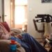An older woman seated at home in Four Corners: The Waiting Game on ABC