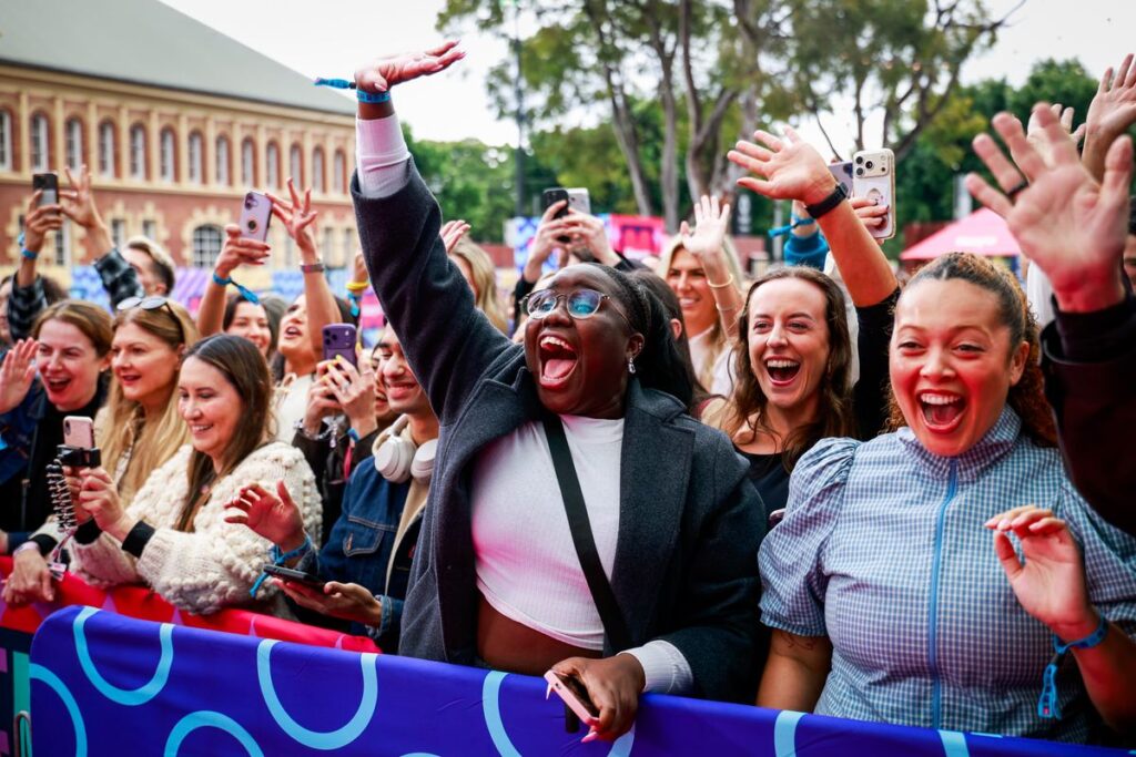 Fans at Hayu FanFest Sydney cheering from the crowd barrier