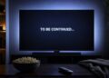 A television screen displays To Be Continued in a dark lounge room for a feature on the best TV cliffhangers.