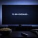 A television screen displays To Be Continued in a dark lounge room for a feature on the best TV cliffhangers.