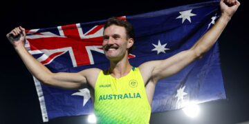 Kurtis Marschall celebrates with the Australian flag at the Glasgow 2026 Commonwealth Games
