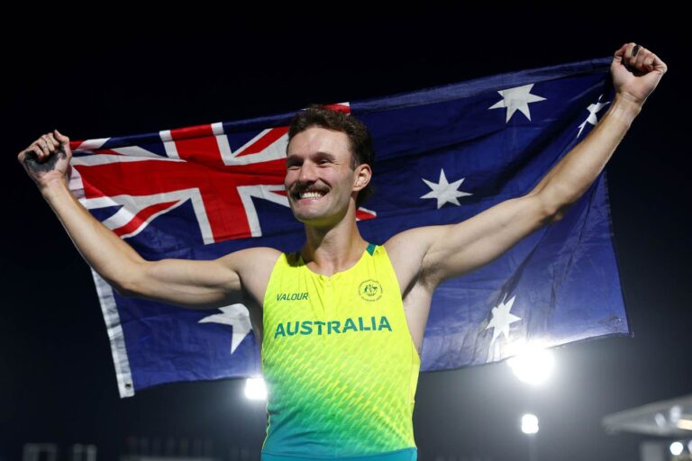 Kurtis Marschall celebrates with the Australian flag at the Glasgow 2026 Commonwealth Games