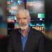 Shaun Micallef in front of studio screens promoting Parents' Evening