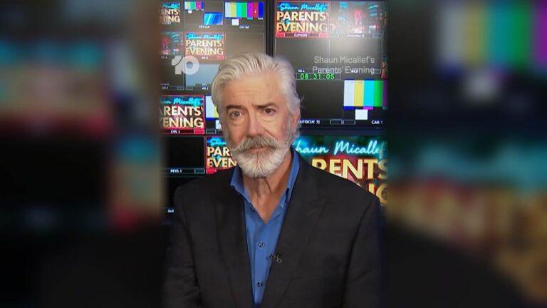 Shaun Micallef in front of studio screens promoting Parents' Evening