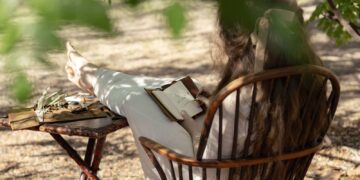 A young woman writing outdoors in an official image for Netflix's The Next Brilliant Career screenwriter initiative