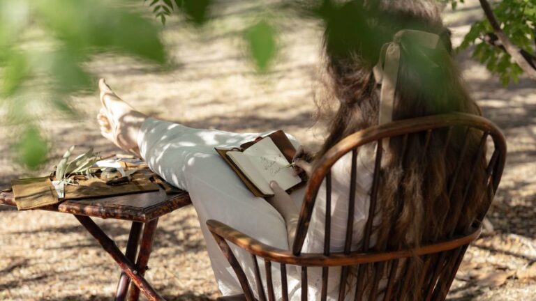 A young woman writing outdoors in an official image for Netflix's The Next Brilliant Career screenwriter initiative
