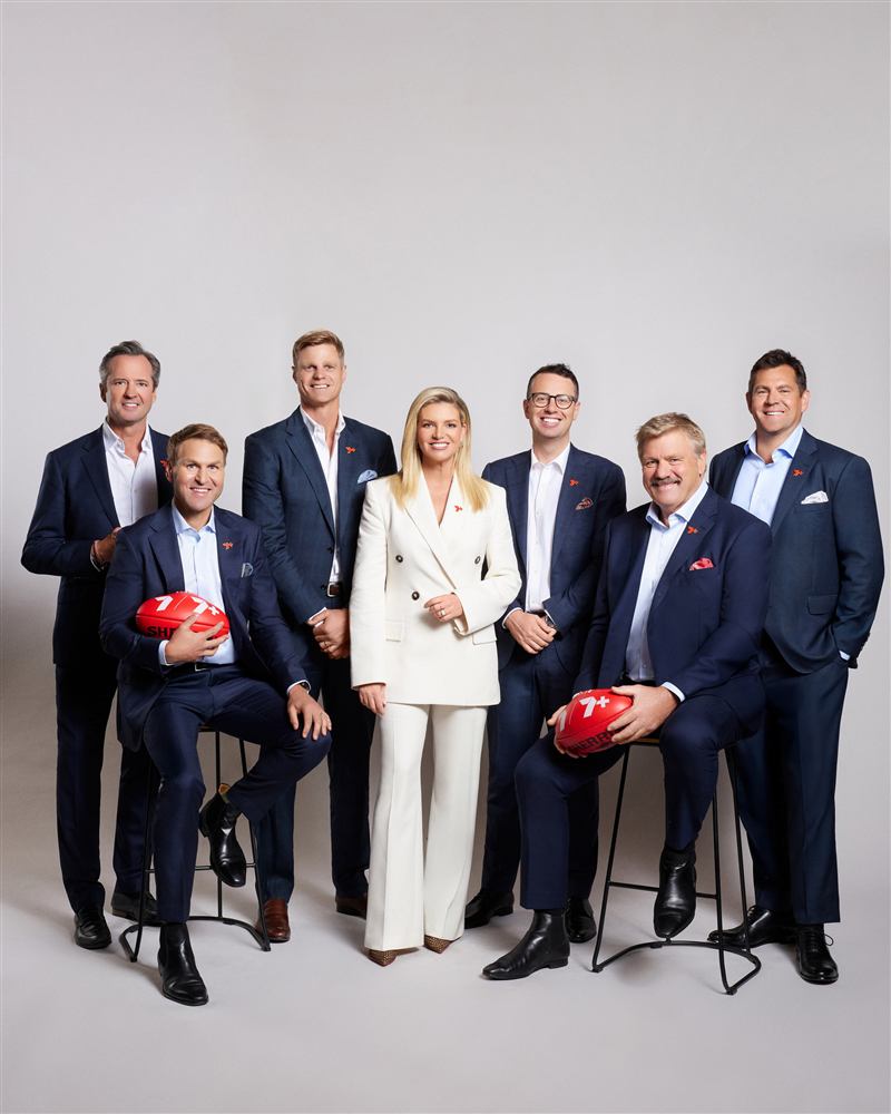 Seven AFL presenters and commentators in a studio portrait