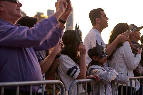 Fans wearing Batman masks and taking photos at the Sydney Opera House Batman Day event.