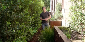 Charlie stands in a garden side passage on Better Homes and Gardens
