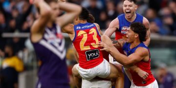 Brisbane Lions players celebrate winning the 2026 AFL Grand Final