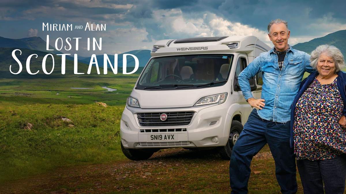 Alan Cumming and Miriam Margolyes beside their campervan in Scotland.